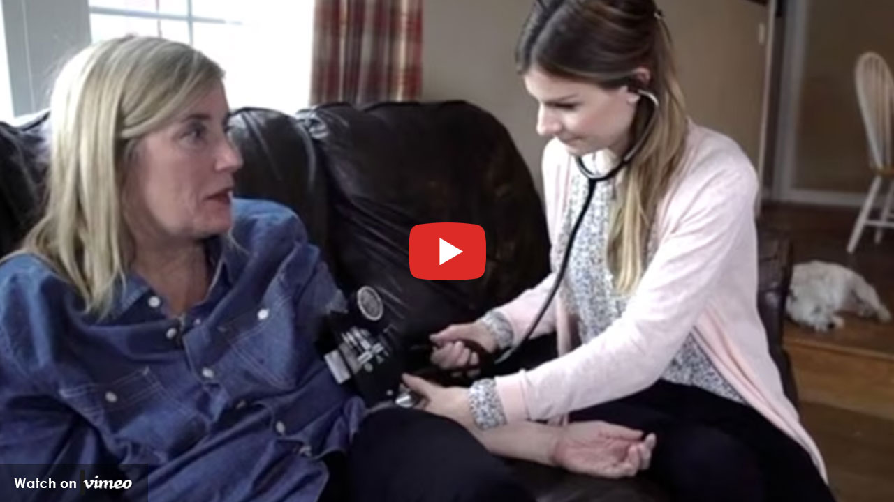 Nurse checking a patient’s blood pressure at home